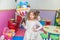 Portrait of happy little girl at birthday party holding balloon