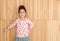 Portrait of happy little girl , wood background,