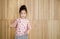 Portrait of happy little girl , wood background