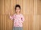 Portrait of happy little girl , wood background