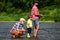 Portrait of happy little son, father and grandfather - three generations of men fishing on river. Family fishermen