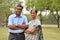 Portrait of a happy looking retired senior Indian man and woman power couple smiling and posing with hands crossed / folded in a