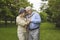 Portrait of happy loving married senior couple hugging in green city park