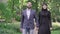 Portrait of happy loving Middle Eastern couple strolling in sunny summer park. Middle shot of smiling bearded man and