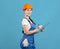 Portrait Of Happy Maintenance Worker Lady In Coverall And Hardhat With Clipboard