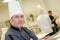 Portrait happy male chef in industrial kitchen