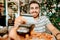 Portrait of happy man paying lunch with credit card, close up details