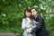 Portrait of happy mather with son and dog Jack Russell in summer park