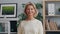 Portrait of happy mature lady looking at camera and smiling standing in office