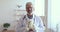 Portrait of happy mature male pediatrician with toy in hands.