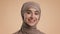 Portrait Of Happy Middle-Eastern Lady Wearing Hijab Over Beige Background