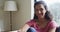 Portrait of happy mixed race woman ,sitting living in room