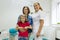 Portrait of a happy mother with child and doctor dentist, in dental office.