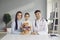 Portrait of happy mother, child and family practitioner smiling and looking at camera