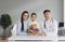 Portrait of happy mother, daughter and their family practitioner smiling at camera