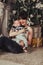 Portrait of happy mother and litle baby near decorated christmas tree with gifts.