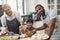 Portrait of happy multi-generation family preparing sweet food together in kitchen