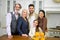 Portrait of happy multigenerational family in kitchen in festive wear