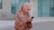 Portrait of happy Muslim business woman enjoy success on mobile phone outdoors. Closeup joyful Islamic girl reading good