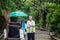 Portrait happy old Asian man street cleaner standing with his arms crossed next to an old gabage cart before going to work with