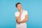 Portrait of happy pensive man in casual white t-shirt looking up with peaceful meditative expression