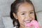 Portrait of happy, positive, smiling, playful girl with donuts