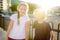 Portrait of a happy preteens girl and boy on a city street during a summer sunset. Friends are walking together. First love