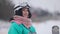 Portrait of happy relaxed young woman standing on snowy ski resort breathing in and out. Carefree Caucasian lady