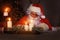 Portrait of happy Santa Claus sitting at his room at home near Christmas tree and answering Christmas letters