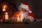 Portrait of happy Santa Claus sitting at his room at home near Christmas tree and answering Christmas letters