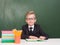 Portrait of a happy schoolboy with books