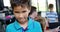 Portrait of happy schoolboy smiling in classroom