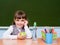 Portrait of a happy schoolgirl of elementary school near chalkboard