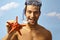 Portrait of happy scuba diver with starfish
