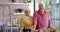 Portrait of happy senior caucasian couple cooking dinner in kitchen at home, slow motion