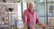 Portrait of happy senior caucasian man cooking dinner in kitchen at home, slow motion