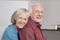 Portrait of happy senior couple at domestic kitchen