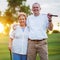 Portrait of happy senior couple playing golf enjoying retirement