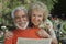 Portrait Of A Happy Senior Couple Reading Newspaper