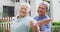 Portrait of happy senior diverse couple dancing in garden