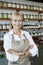 Portrait of a happy senior employee with arms crossed in spice store