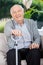 Portrait Of Happy Senior Man Holding Metal Cane