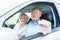 Portrait of a happy senior man showing his driving license while