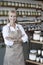 Portrait of a happy senior woman with arms crossed in spice store