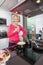 Portrait of happy senior woman with champagne glass cooking food in kitchen