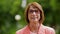 Portrait of happy senior woman in glasses at park