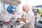 Portrait of happy senior woman preparing food in domestic kitchen