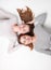 Portrait of happy sisters lying on the floor