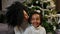 Portrait of happy smiling African American mom and little daughter wishing Merry Christmas and Happy New Year. Family on