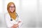 Portrait of happy smiling Asian muslim woman wearing hijab and suite. Confidence female doctor with crossed arms, healthcare and